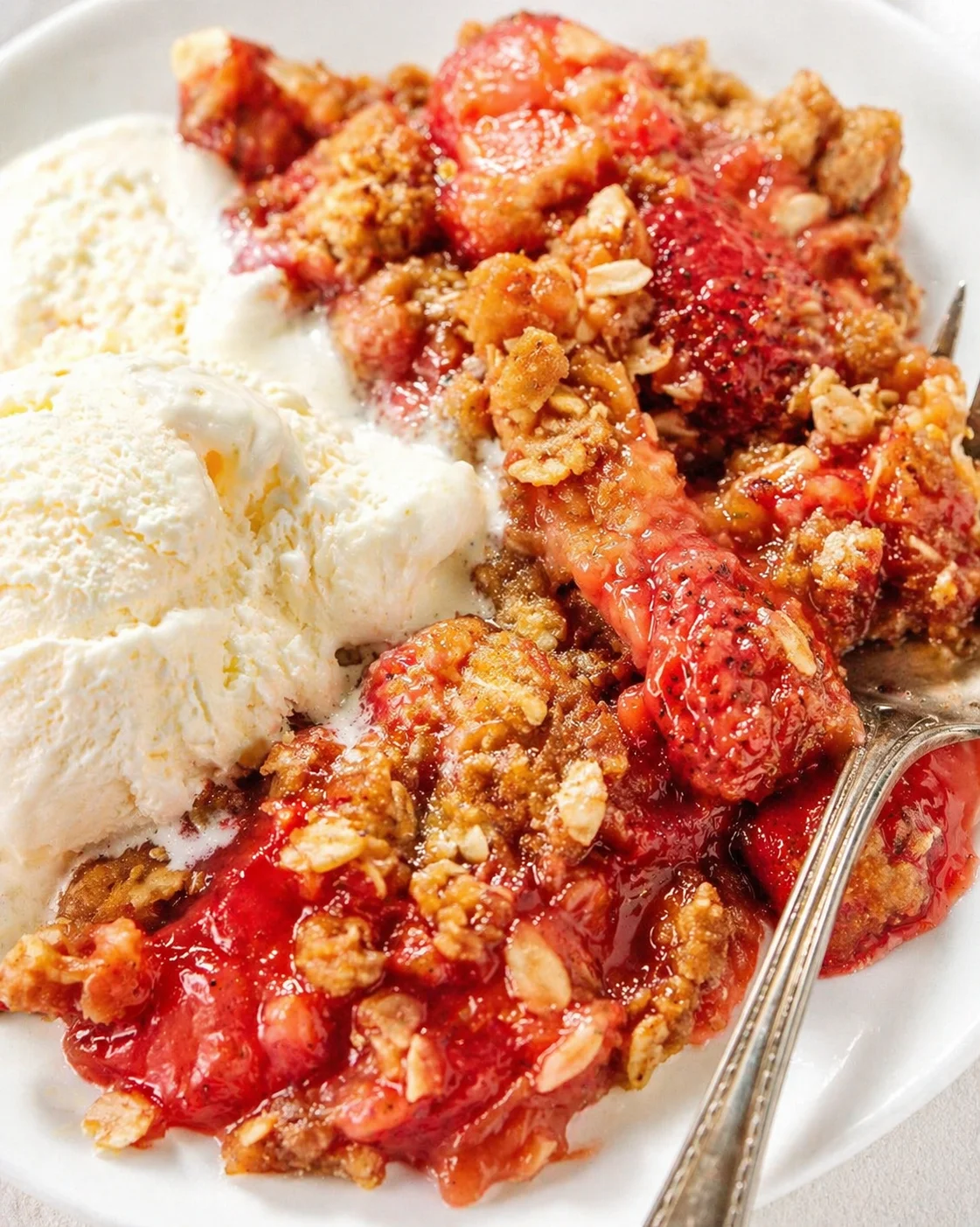 Final plated Strawberry Rhubarb Crisp served as a hero shot