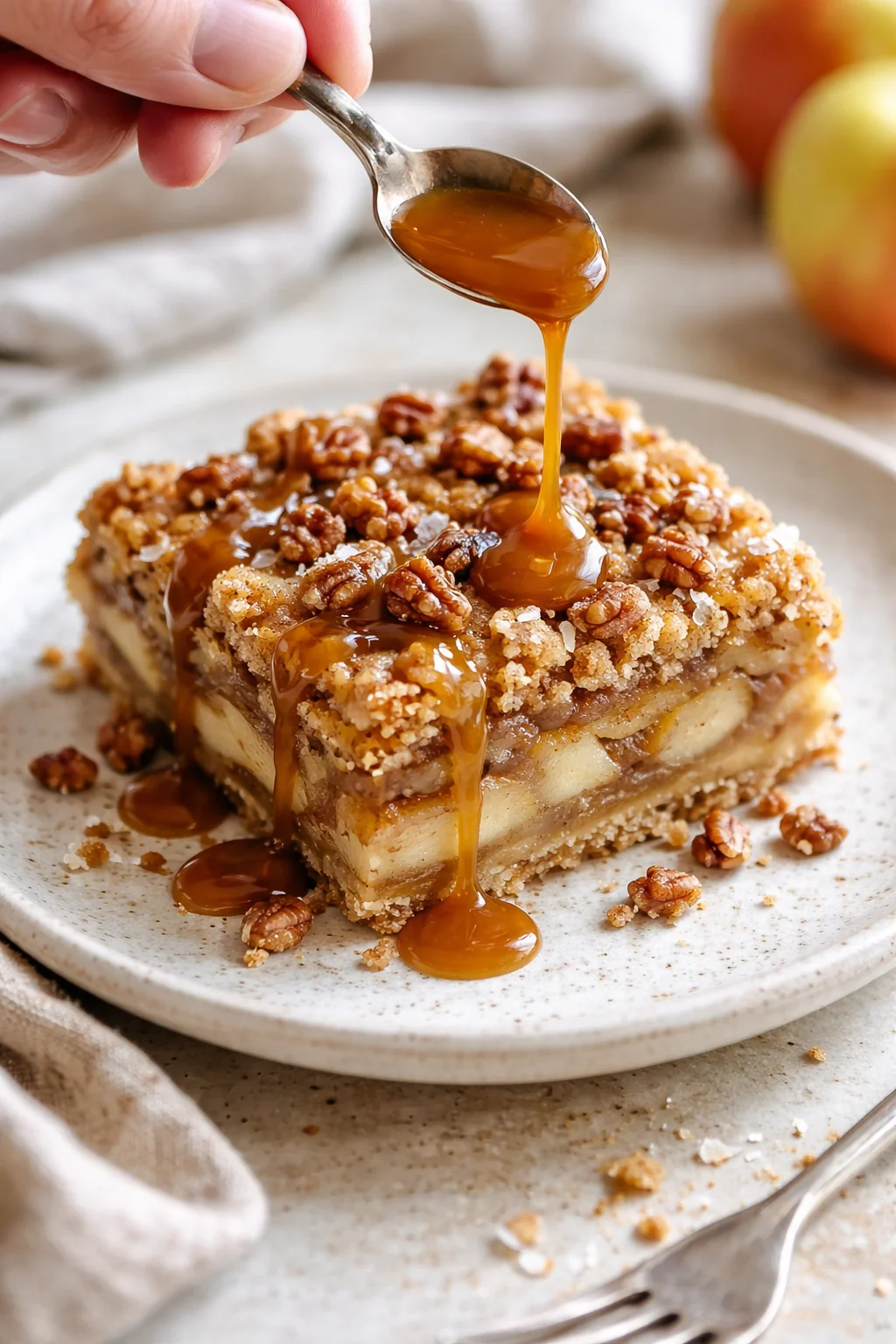 plated caramel-apple-pecan bar with pecans and warm caramel drizzle over top